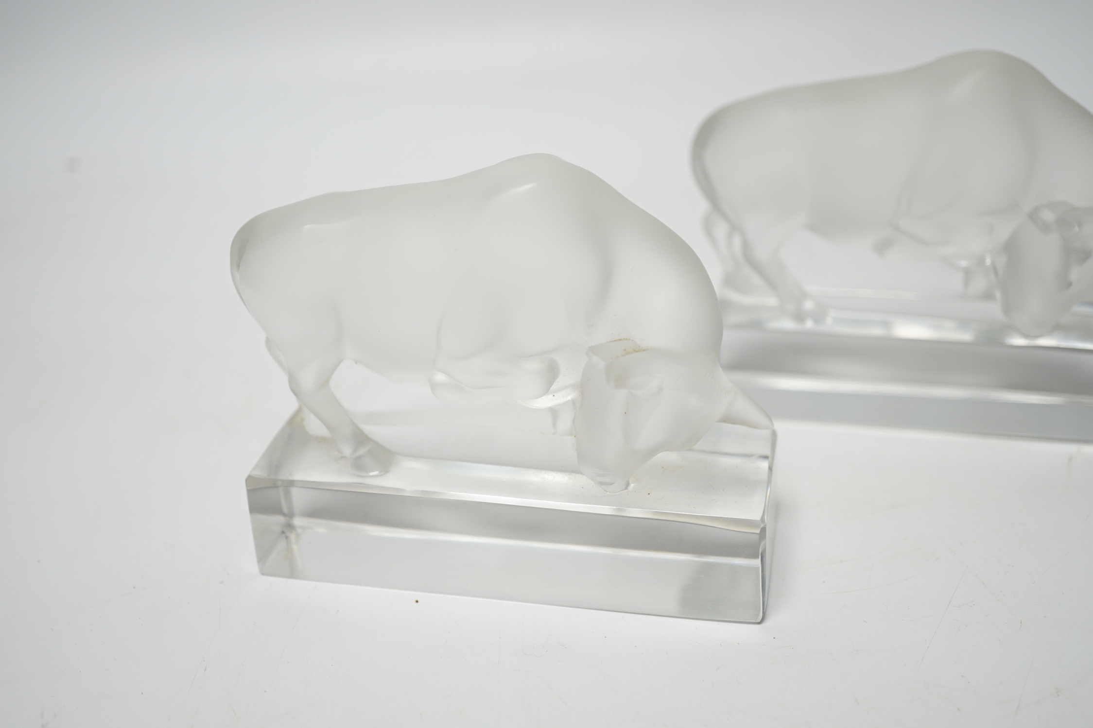 Rene Lalique, two frosted glass paperweights modelled as a bull, signed ‘Lalique France’ to base, 9cm high